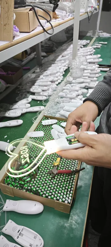 Worker assembling reusable LED wristbands